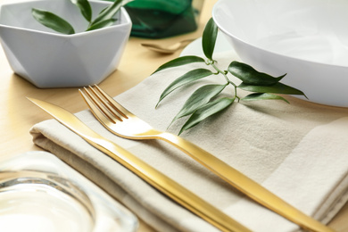 Elegant table setting with green leaves, closeup