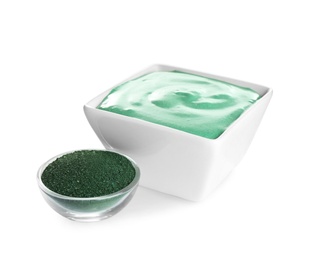 Photo of Freshly made spirulina facial mask in bowl and powder on white background