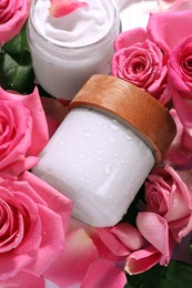 Jars of face cream among beautiful roses