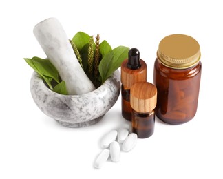 Mortar with fresh green plantain leaves, extracts and pills on white background