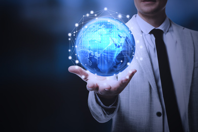 Image of Business analytics. Man demonstrating virtual image of globe with network connection, closeup  