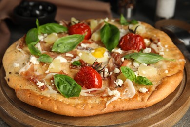 Photo of Delicious homemade pita pizza on wooden board, closeup