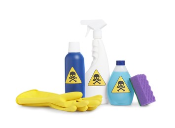 Photo of Bottles of toxic household chemicals with warning signs, gloves and scouring sponge on white background