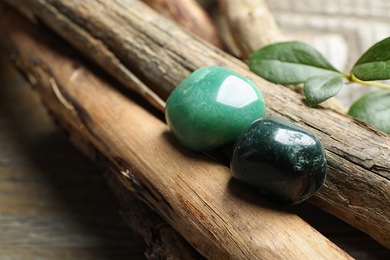 Photo of Beautiful green aventurin and heliotrope gemstones with wooden sticks