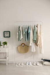 Dressing room interior with clothing rack and nightstand