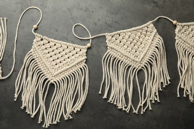 Photo of Stylish beige macrame on grey table, top view