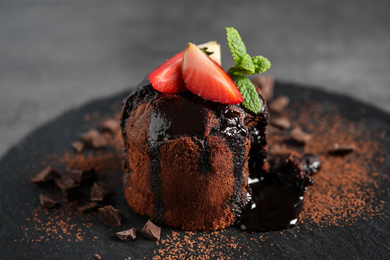 Delicious warm chocolate lava cake on slate board, closeup