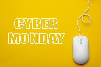 Text Cyber Monday and wired computer mouse on yellow background, top view
