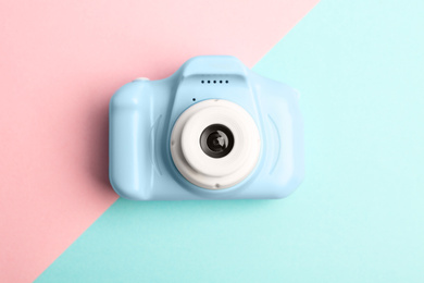 Light blue toy camera on color background, top view. Future photographer