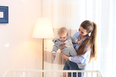 Photo of Teen nanny with cute little baby at home. Space for text