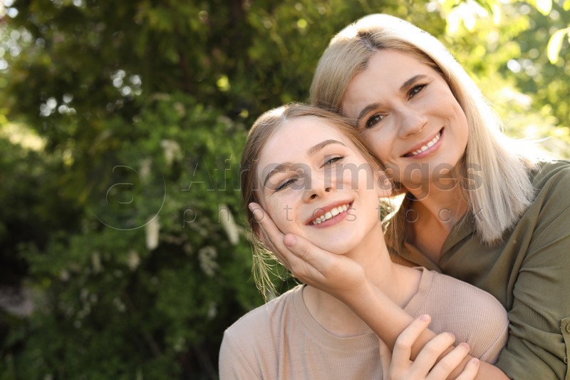 Happy mother with her daughter spending time together in park on sunny day