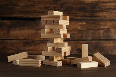 Jenga tower and wooden blocks on table