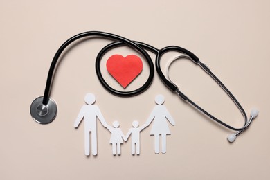 Paper family figures, red heart and stethoscope on beige background, flat lay. Insurance concept