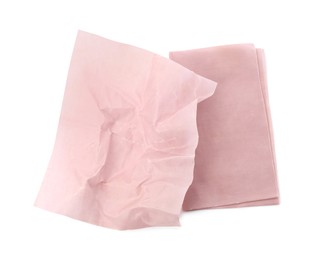Pink reusable beeswax food wraps on white background, top view