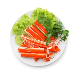 Photo of Plate of delicious crab sticks with greenery isolated on white, top view