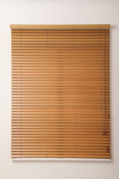 Modern window with closed wooden blinds indoors