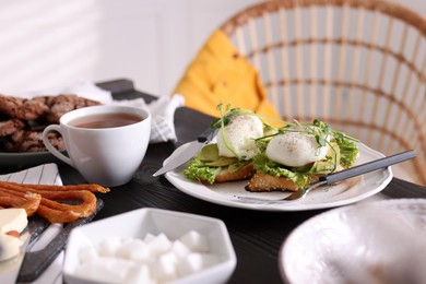 Delicious sandwiches with eggs and avocado served on buffet table for brunch