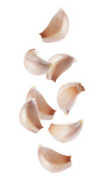 Set of falling garlic cloves on white background