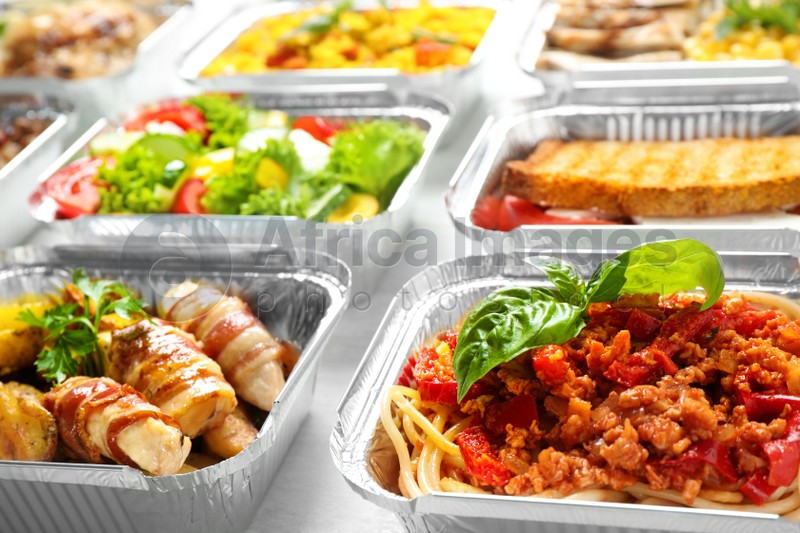 Lunchboxes on white wooden table, closeup. Healthy food delivery