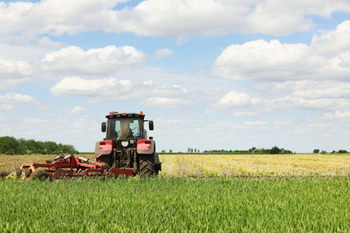 Modern agricultural machinery in field on sunny day