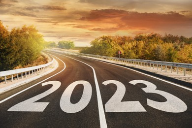 Start new year with fresh vision and ideas. 2023 numbers on asphalt road