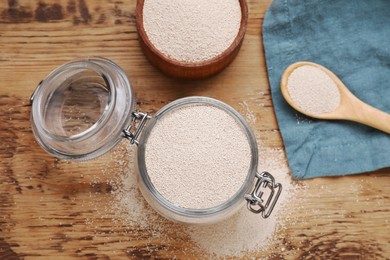 Photo of Active dry yeast on wooden table, flat lay