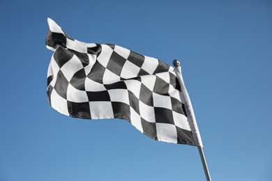 Checkered finish flag on light blue background