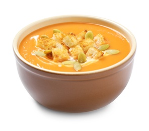 Tasty creamy pumpkin soup with croutons and seeds  in bowl on white background