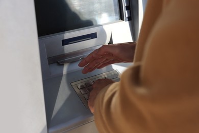 Photo of Man using modern cash machine, closeup of hand