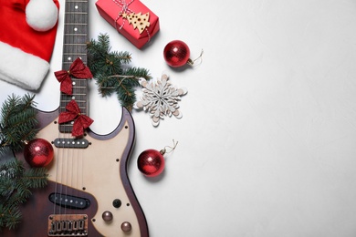 Guitar and festive decorations on white background, flat lay with space for text. Christmas music