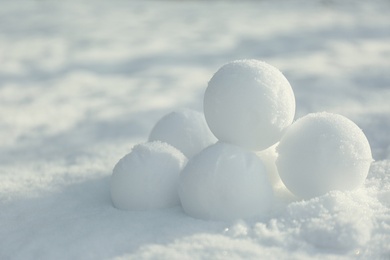 Perfect round snowballs on snow outdoors, closeup