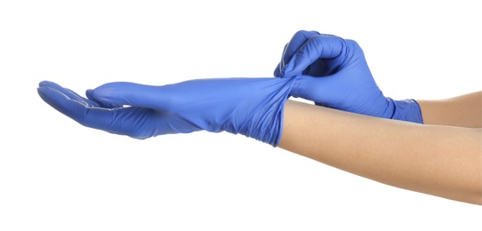 Woman putting on blue latex gloves against white background, closeup of hands
