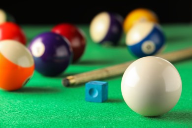 Classic white billiard ball on green table. Space for text
