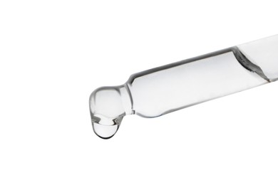 Dripping clear facial serum from pipette on white background, closeup