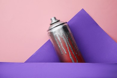 Used can of spray paint on color background, top view. Graffiti supply