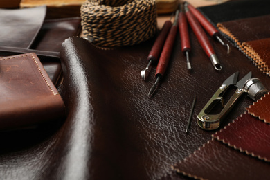 Leather samples and tools as background, closeup