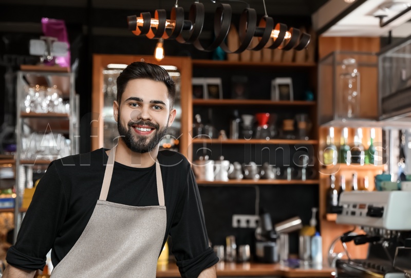 Portrait of smiling barista in coffee shop. Space for text