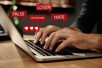 Image of Man using laptop and icons with offensive messages, closeup. Cyber bulling concept