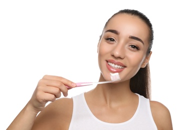 Woman holding toothbrush with paste on white background