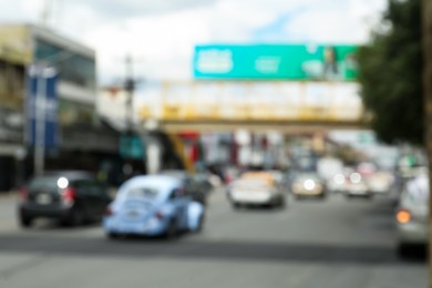 Blurred view of cars on road in city. Bokeh effect