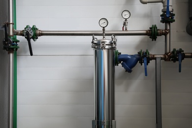 Photo of Pressure gauges and pipes indoors. Production machinery on modern granary