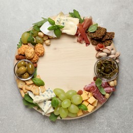 Different tasty appetizers on light table, top view