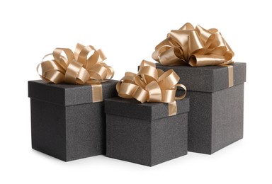 Black gift boxes with golden bows on white background