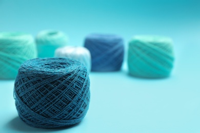 Clew of knitting threads on color background, space for text. Sewing stuff