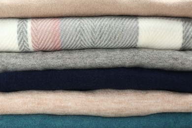 Photo of Stack of cashmere clothes as background, closeup