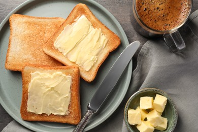 Delicious toasts served with butter and coffee on grey wooden table, flat lay