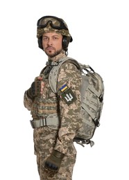 Soldier in Ukrainian military uniform with tactical goggles and backpack on white background
