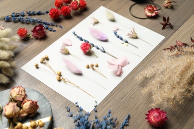 Composition with beautiful dry flowers on wooden background