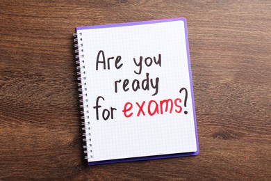 Notebook with question Are You Ready For Exams on wooden table, top view