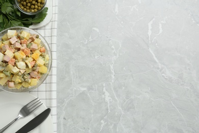 Delicious russian salad Olivier served on light grey marble table, flat lay with space for text